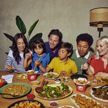 Family Sitting at Table Enjoying Panda Express